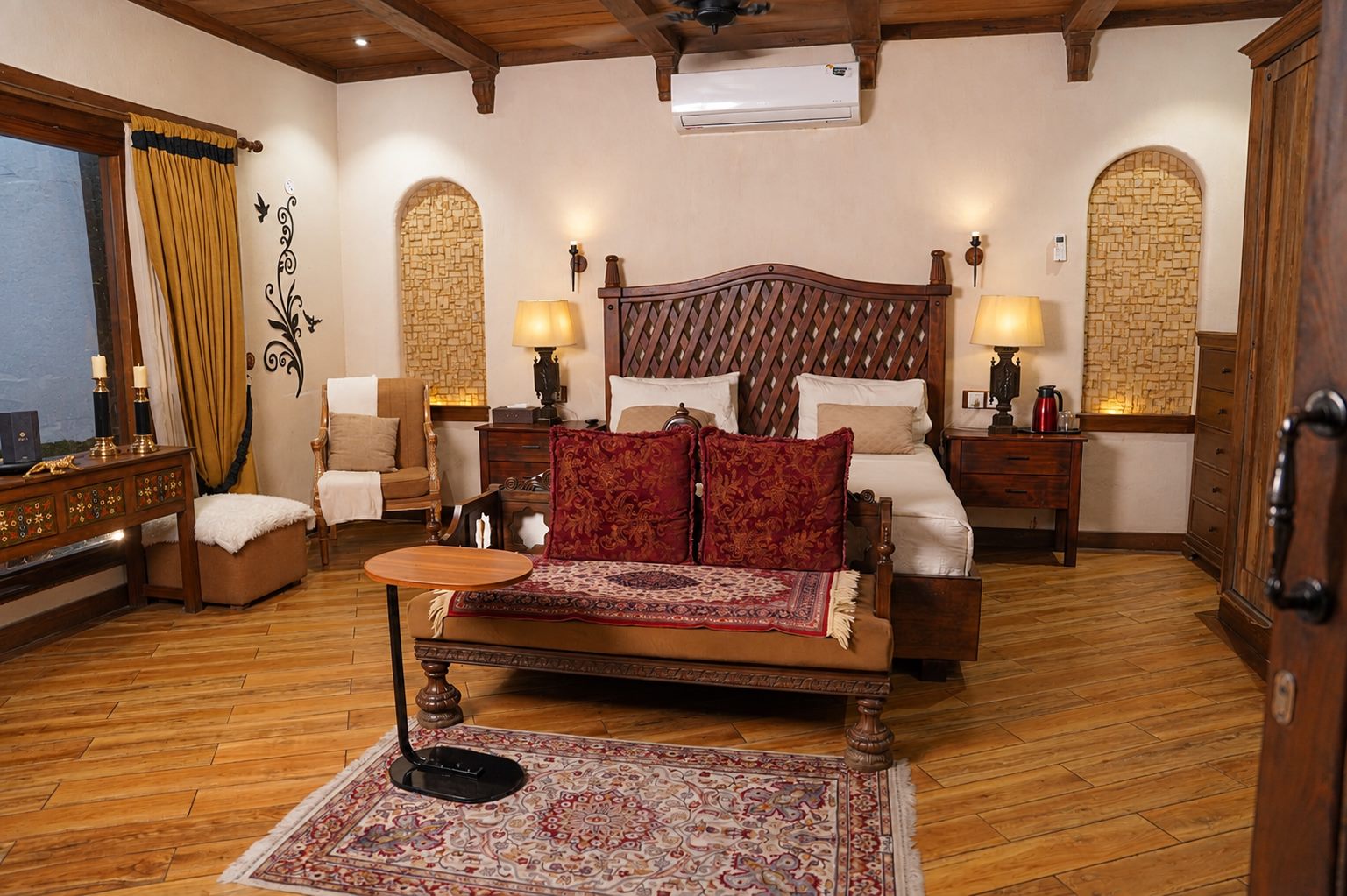 Guest bedroom with tufted headboard and carved daybed